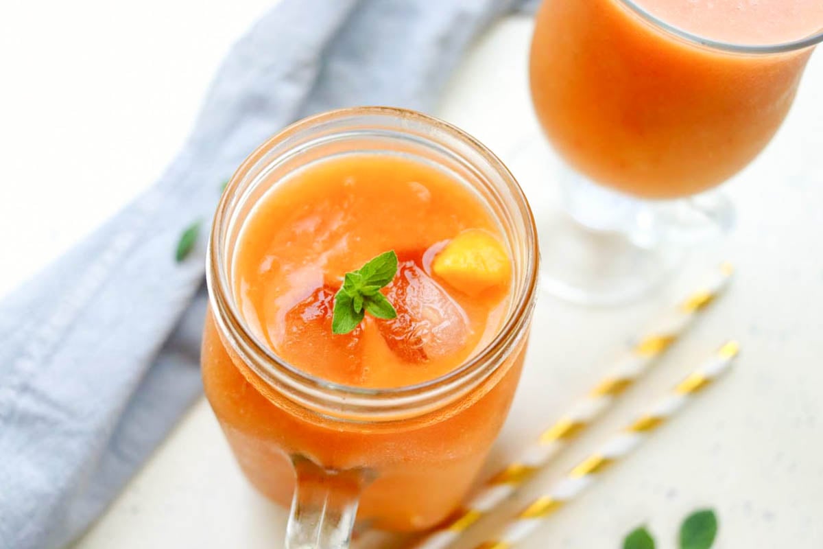 top view of orange smoothie in a jar.