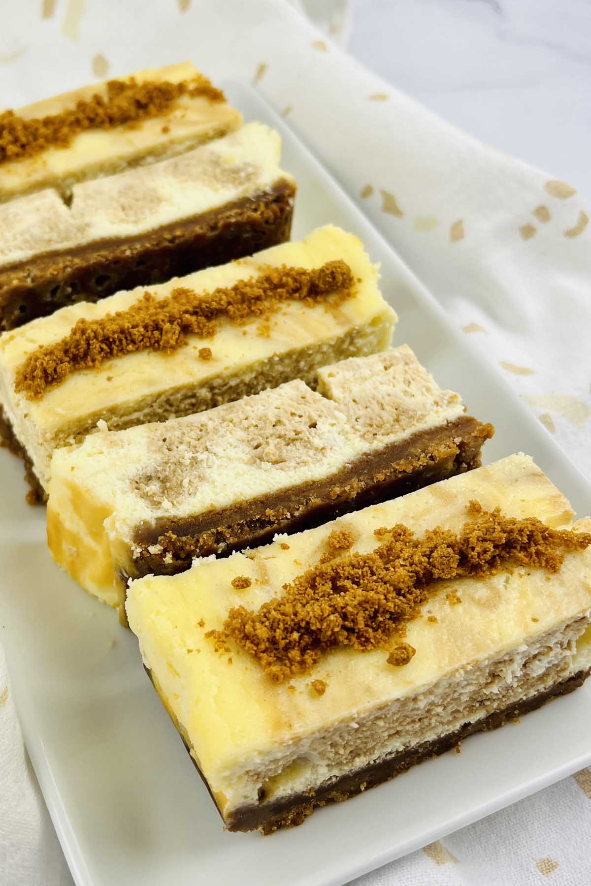 Cheesecake bars on a plate.