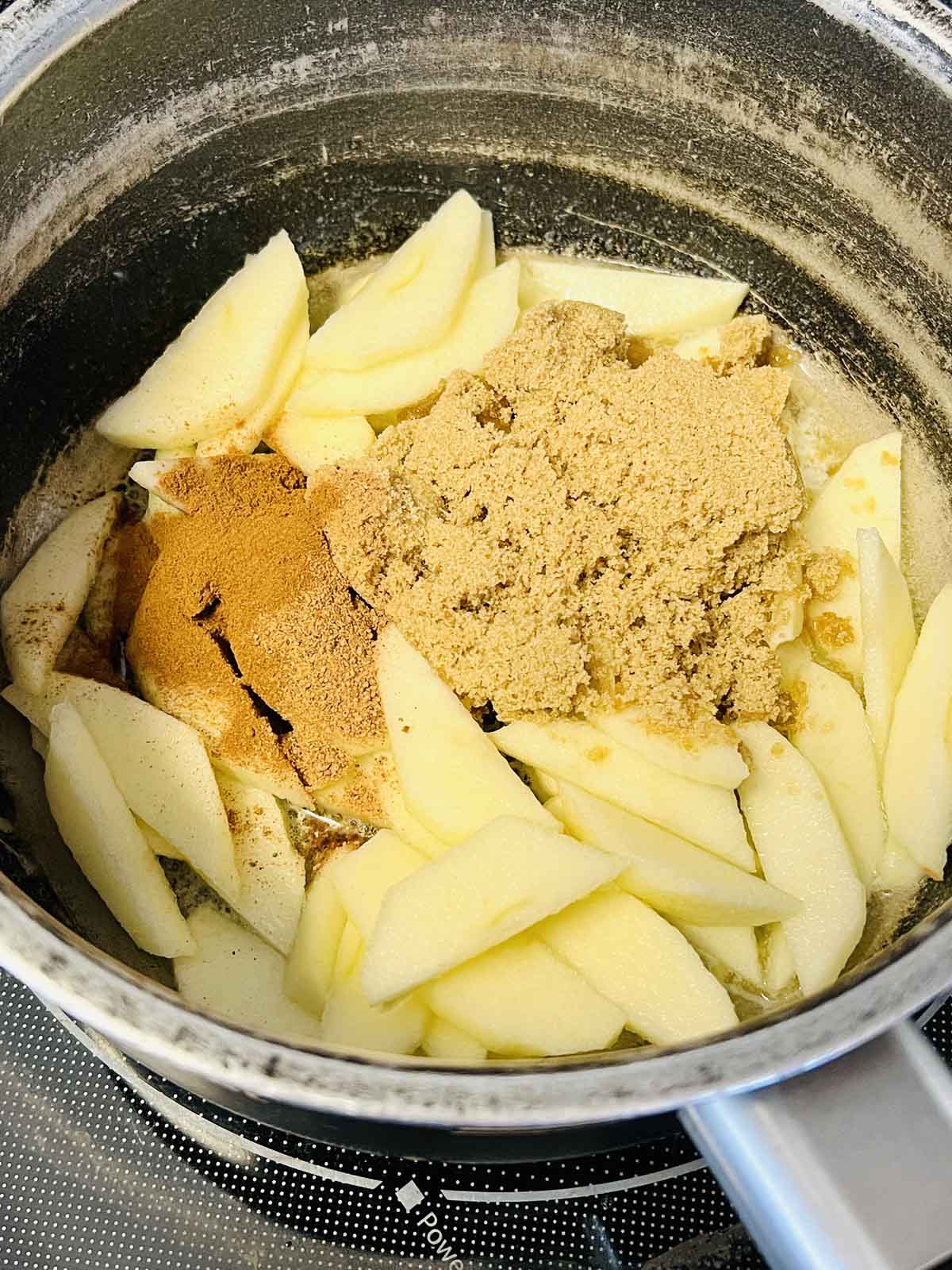 Apples and brown sugar in a pan.