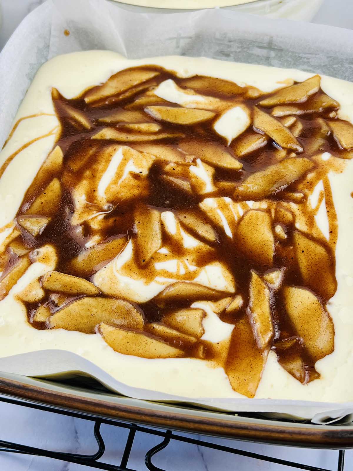 Caramelized apples over the cheesecake mixture.