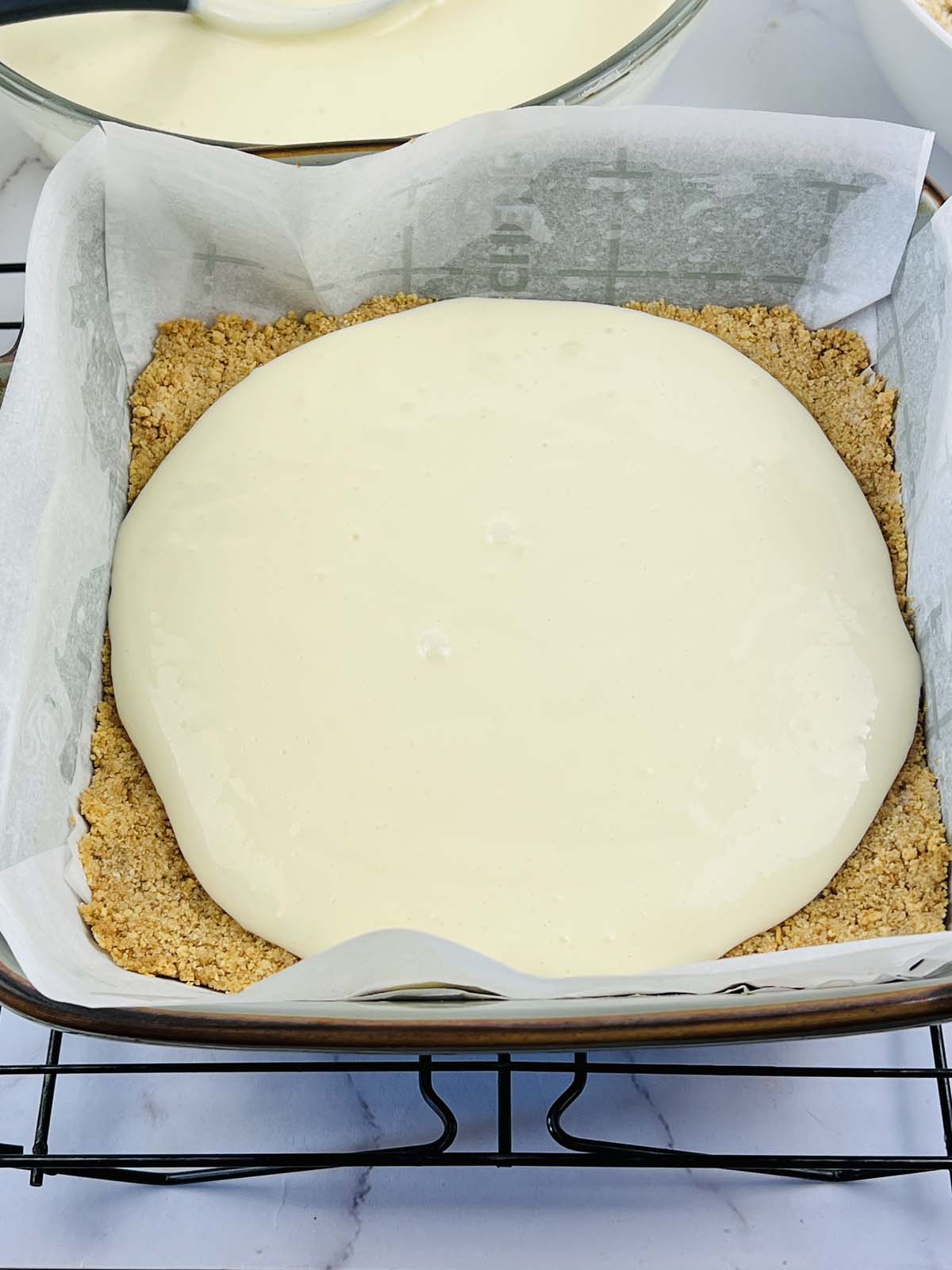 Cheesecake filling poured over the crust.