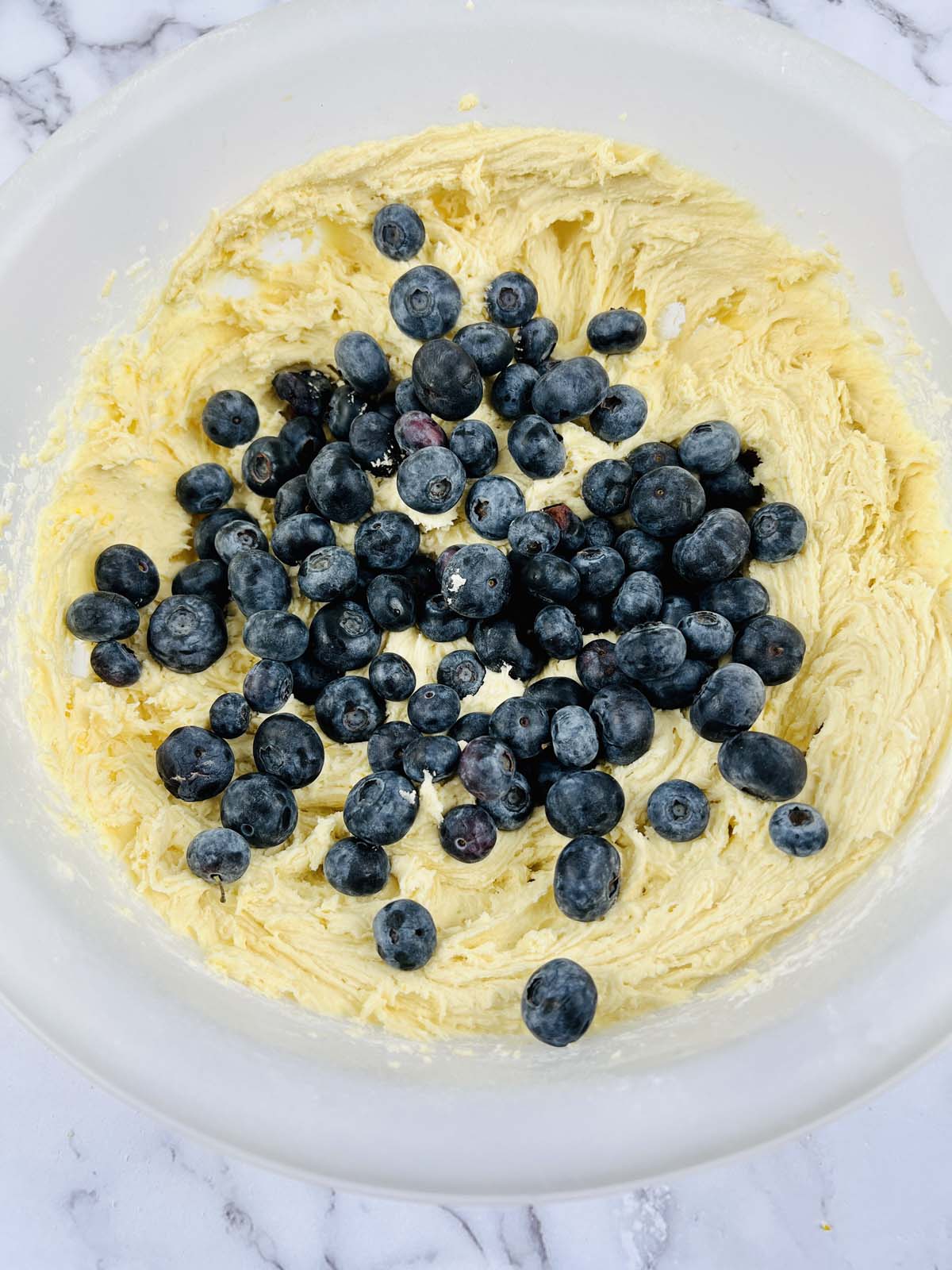 Blueberries on top of cookie dough.