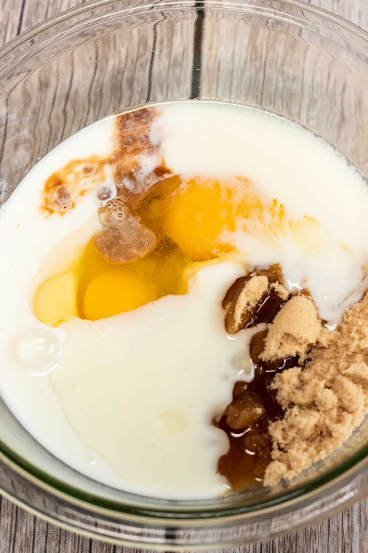 Buttermilk, vegetable oil, eggs, vanilla and brown sugar in a mixing bowl.
