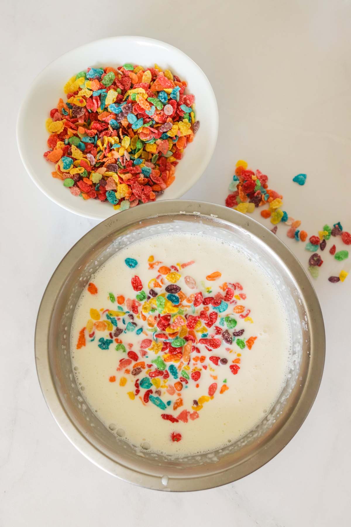 Fruity Pebbles cereal on top of the ice cream mixture.