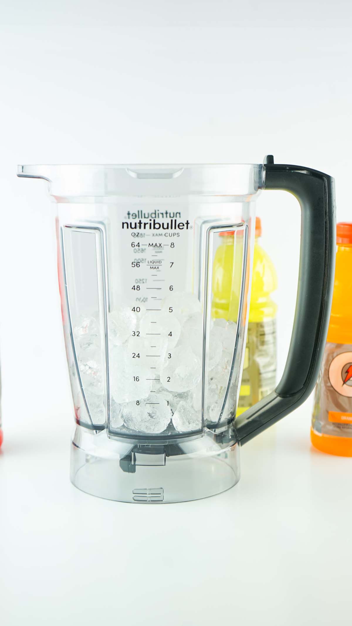 A blender filled halfway with ice cubes.