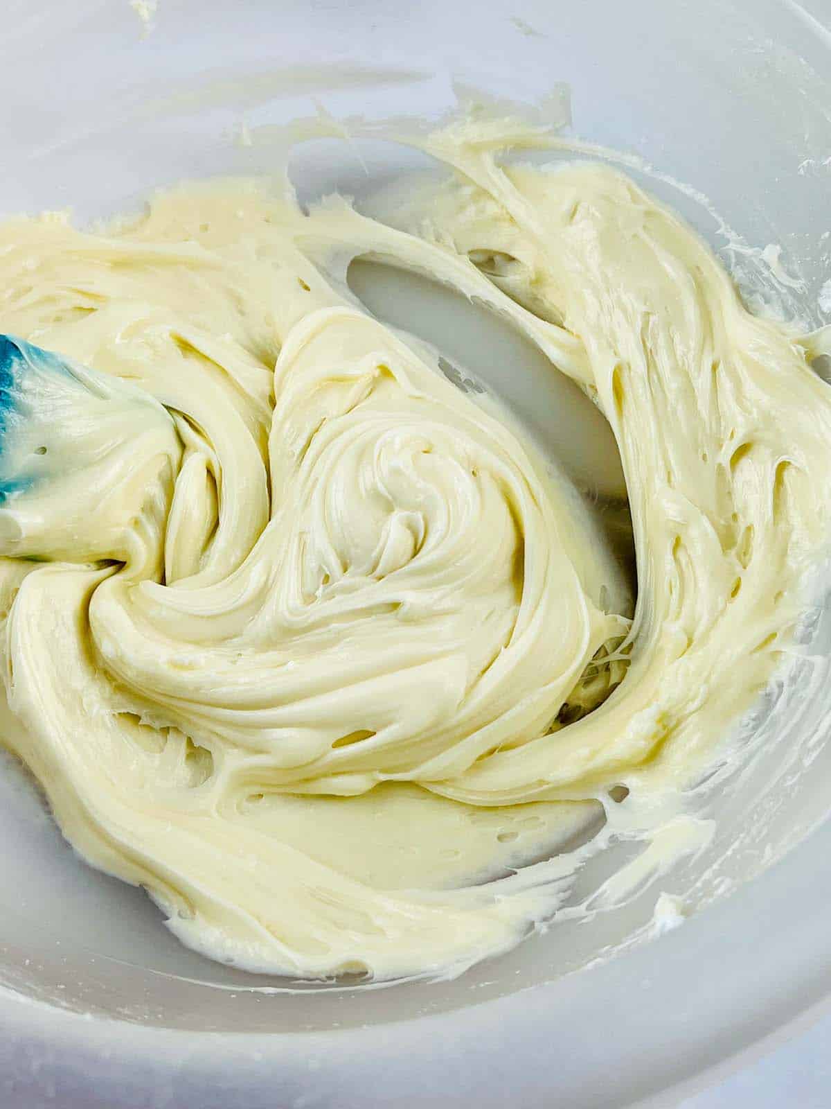 Frosting mixed together in a mixing bowl.