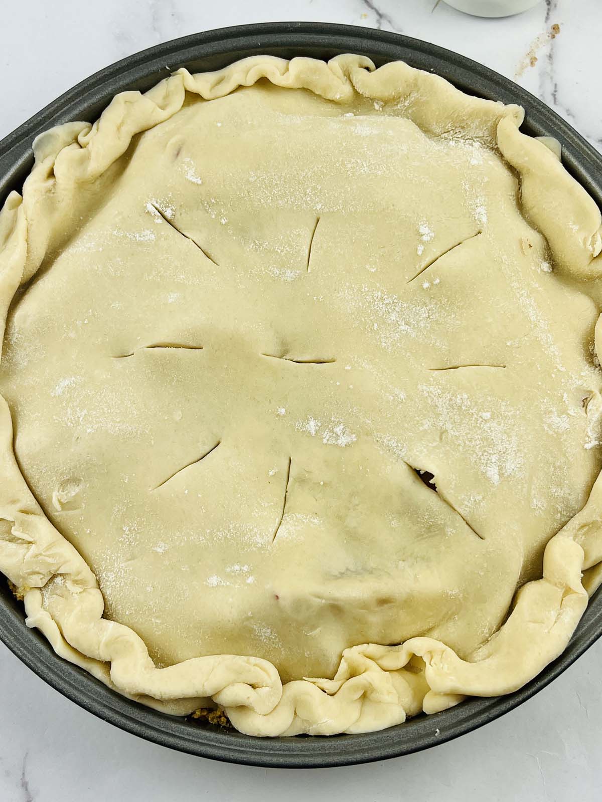 Unbaked apple pie in a pie tin.