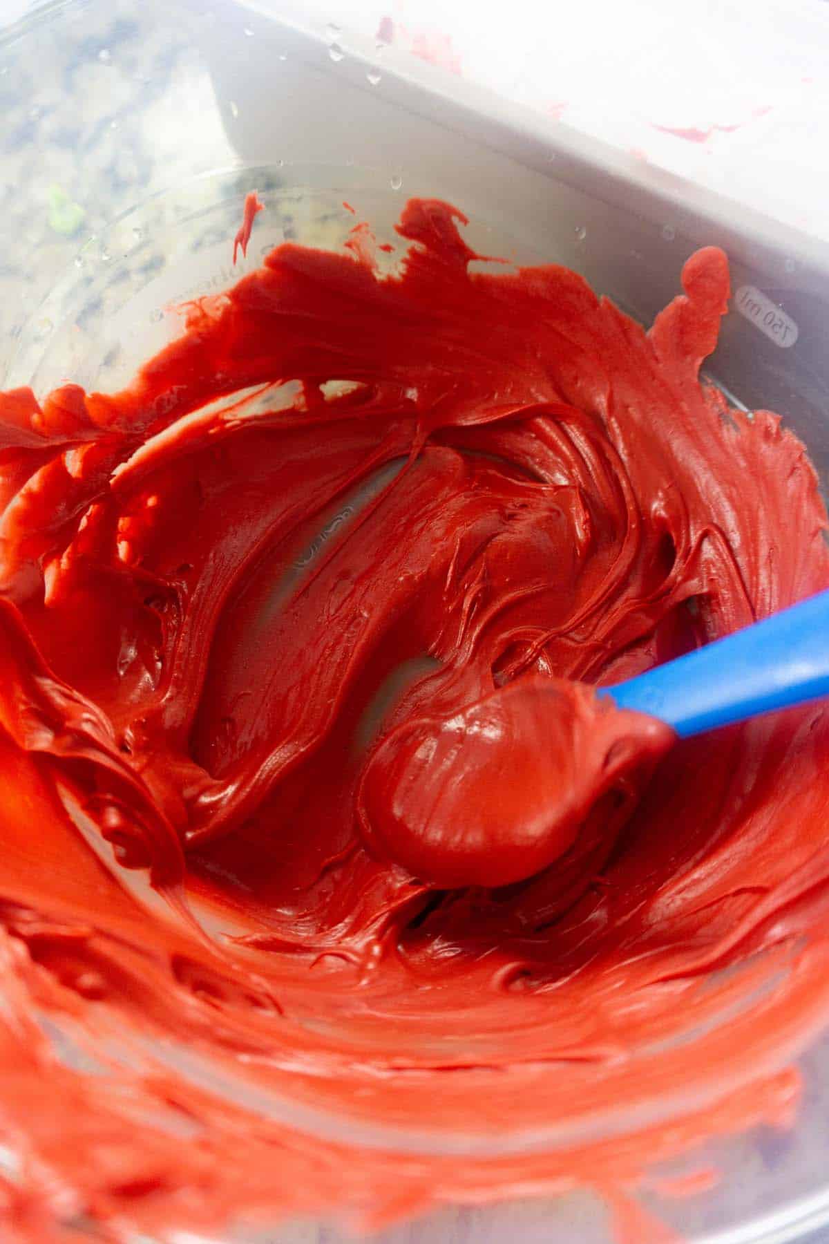 Red candy melts melted in a mixing bowl.