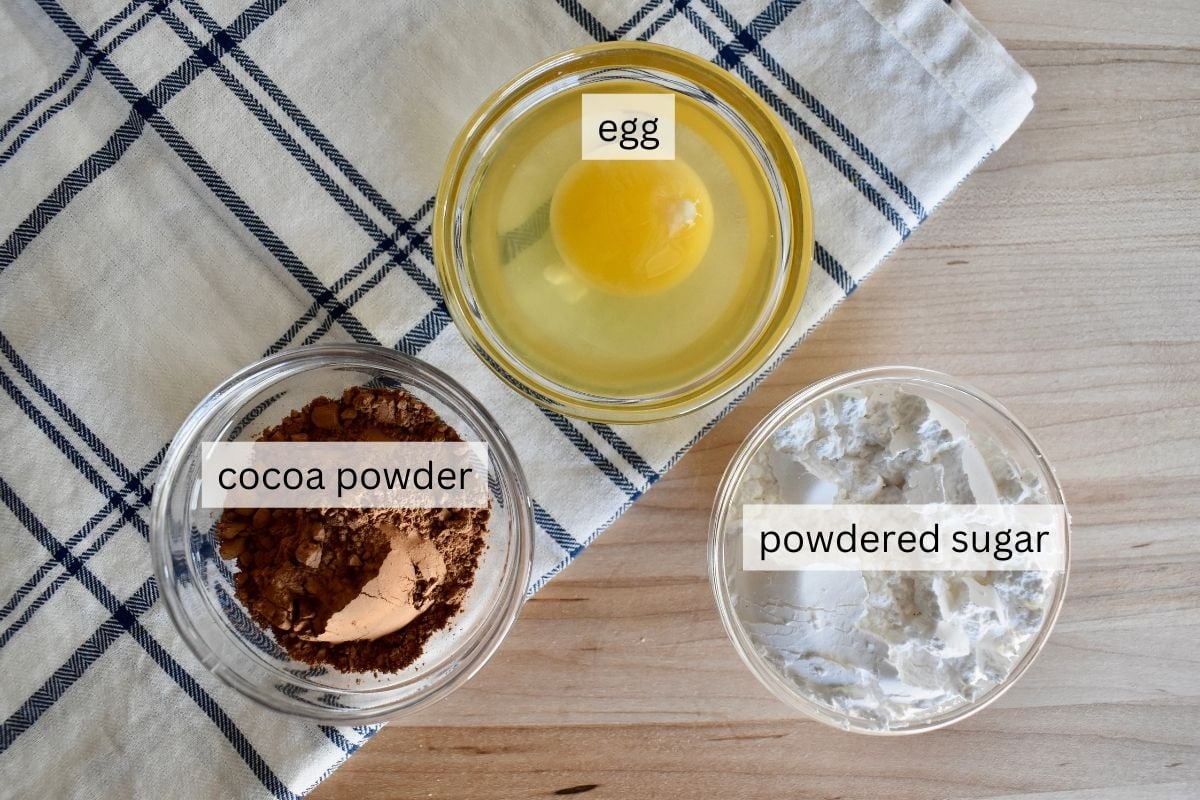 To make the recipe you'll need an egg, powdered sugar, and cocoa powder.