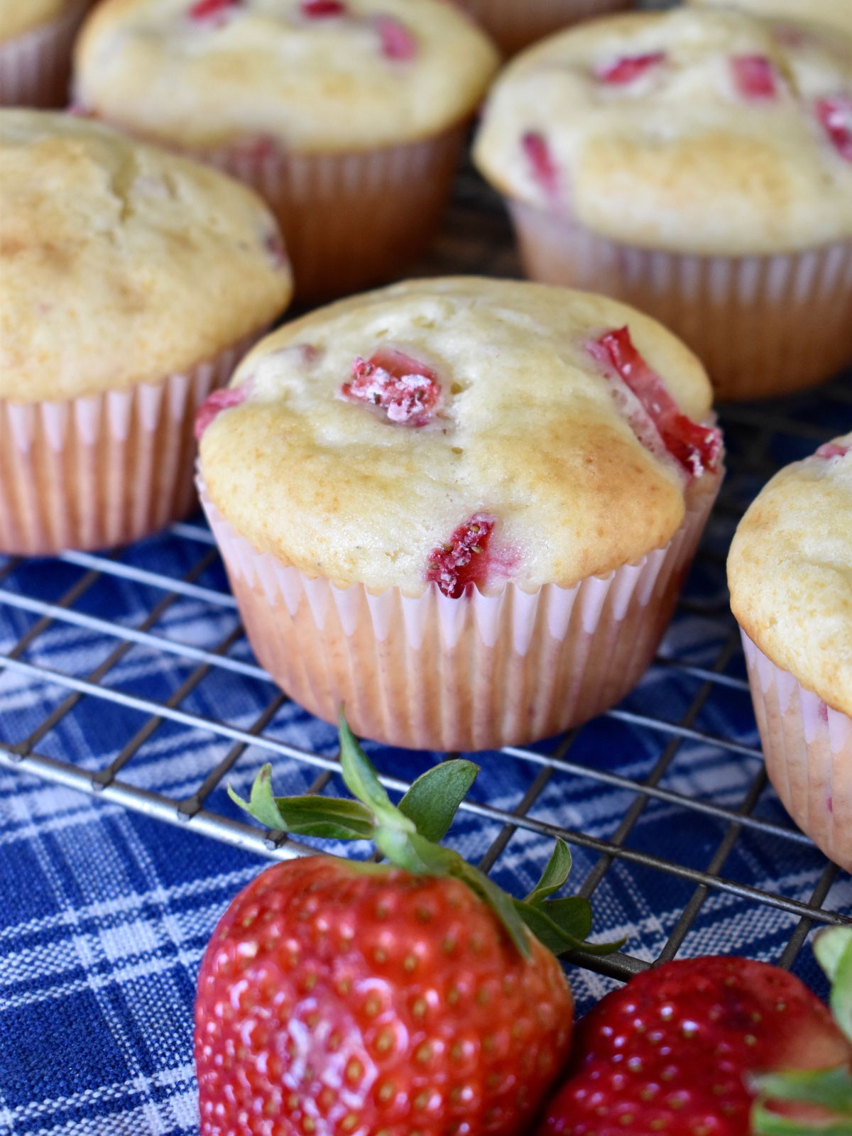 Strawberry Cream Cheese Muffins on a wire cooling rack. 