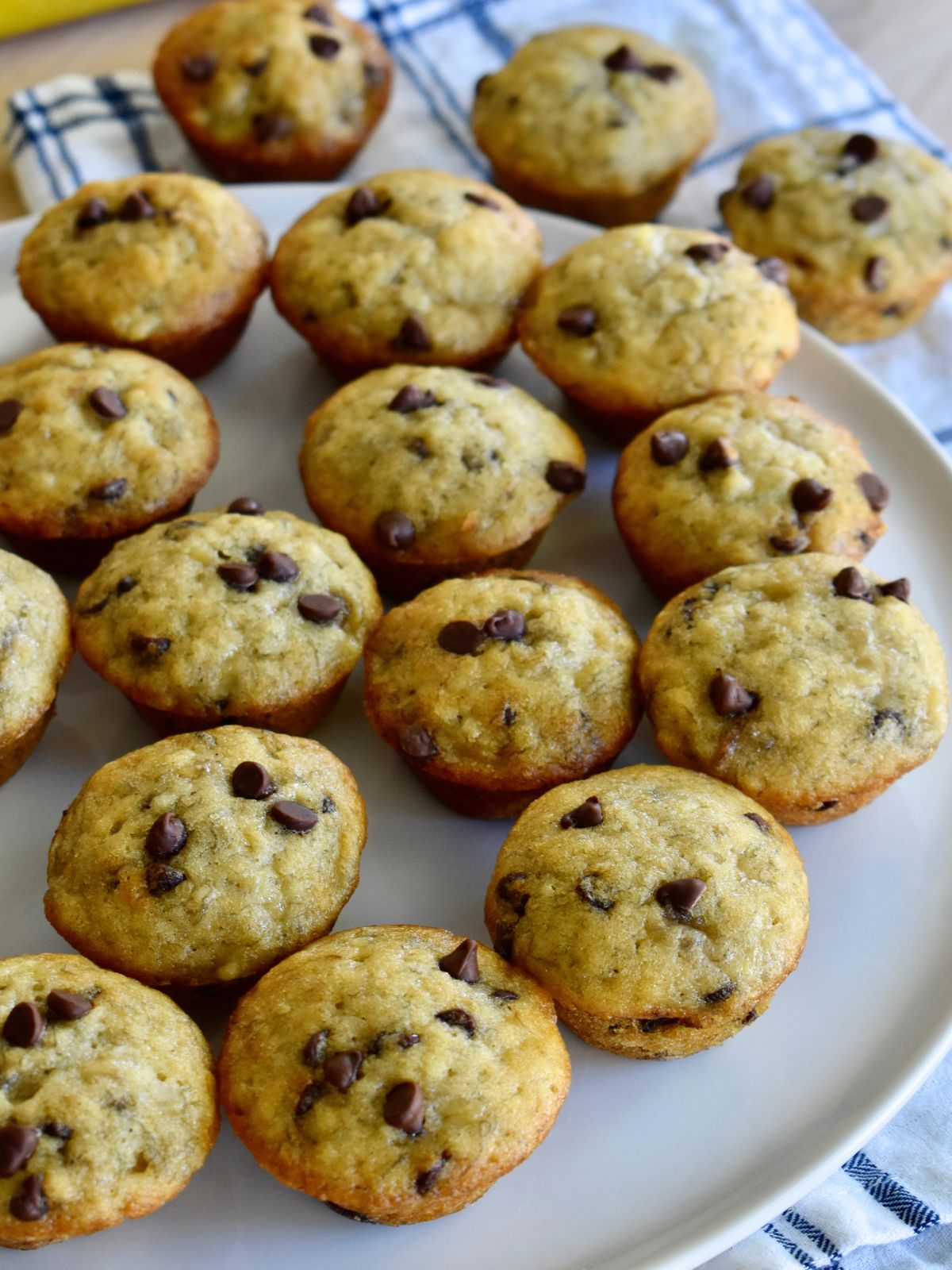 Mini Banana Chocolate Chip Muffins on a white plate. 