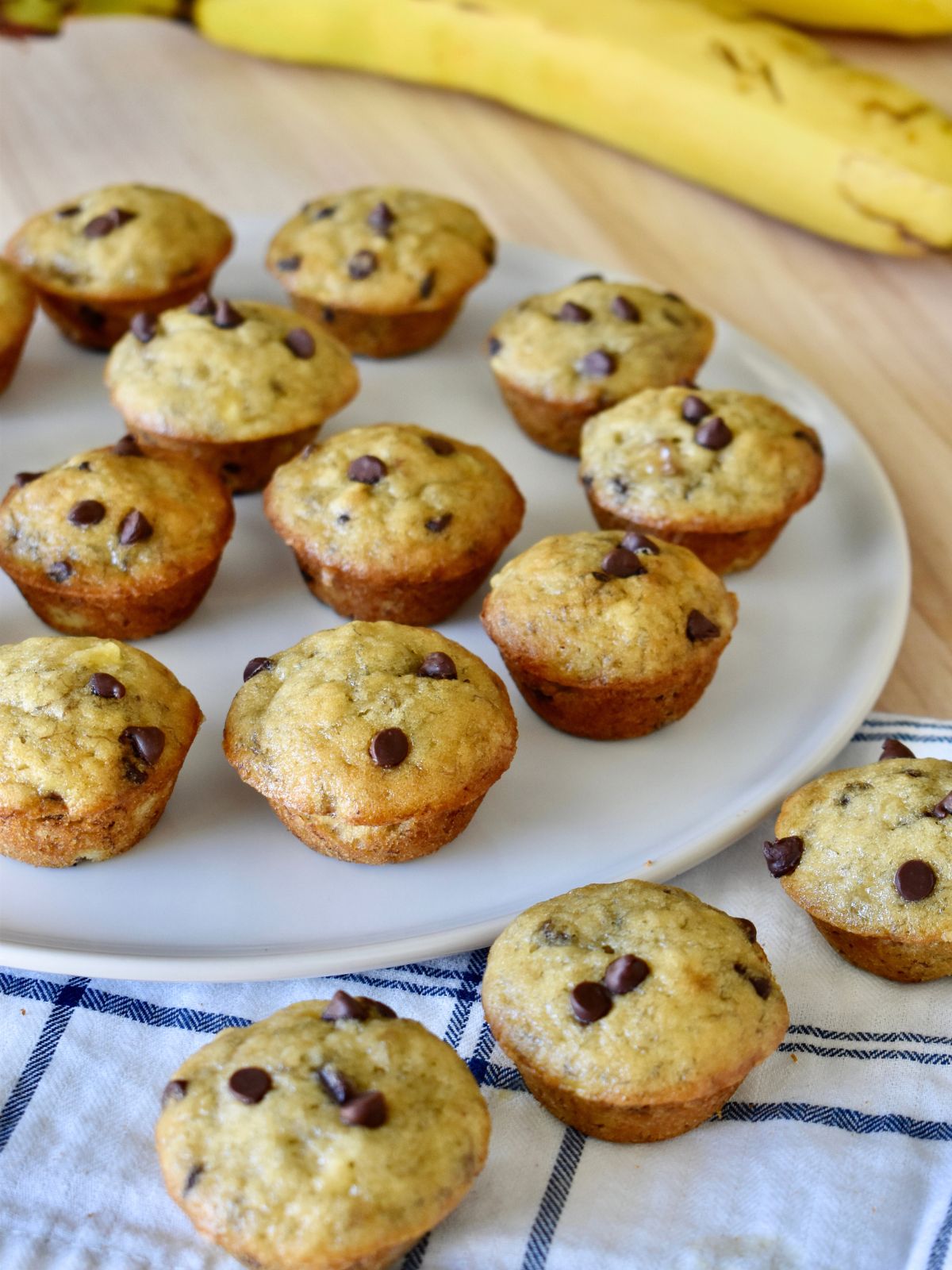 Mini Banana Chocolate Chip Muffins on a white plate. 