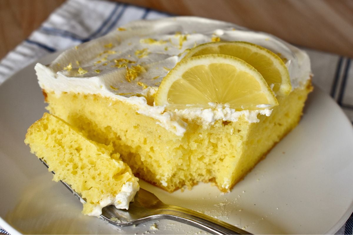 Lemon Poke Cake with a fork on the plate. 