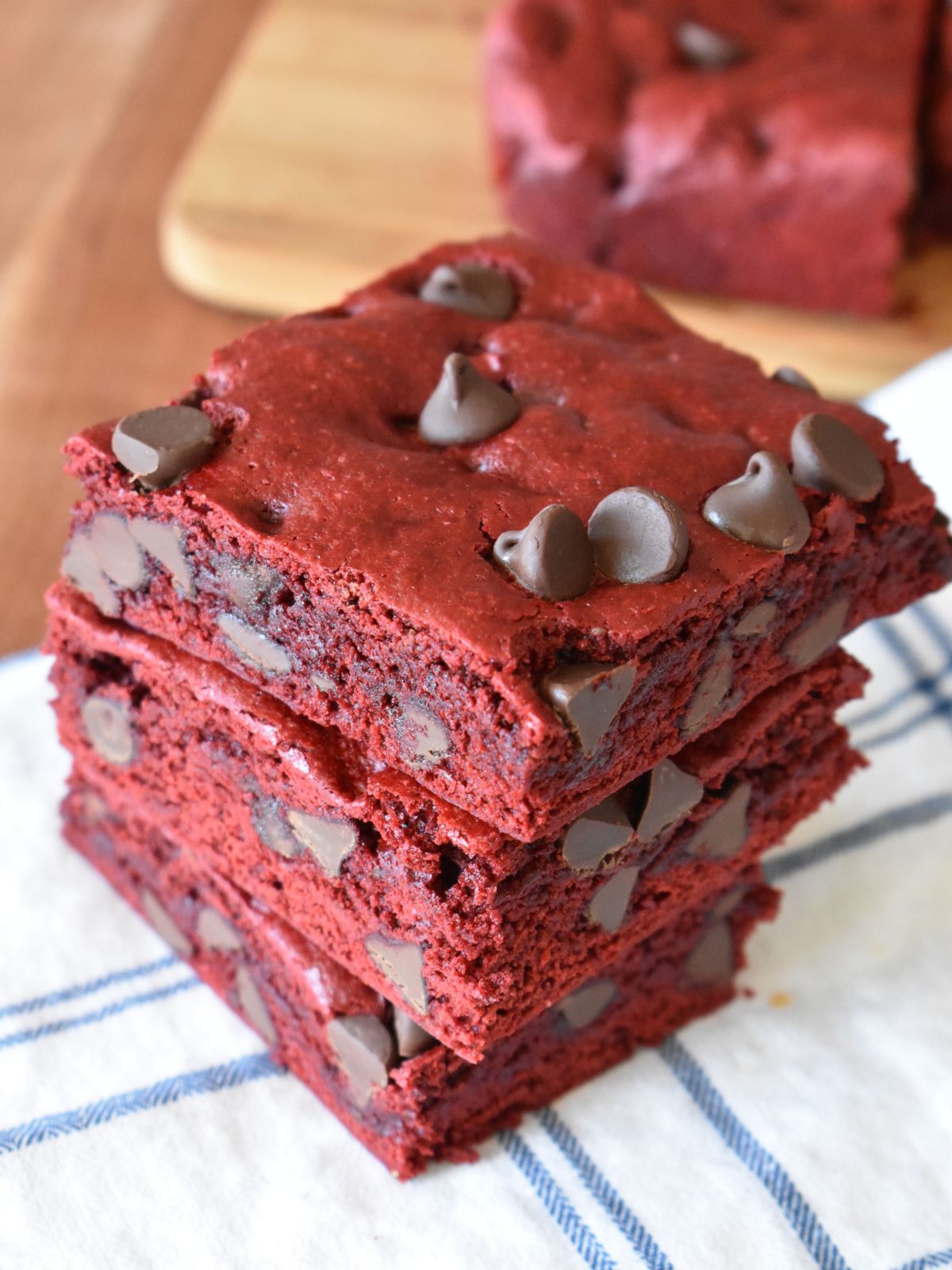 Red velvet cake mix brownies with chocolate chips stacked on each other. 