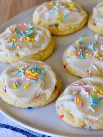 Funfetti Cookies with Cake mix and frosting on a white round plate.