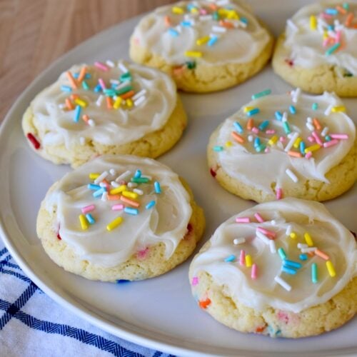 Funfetti Cookies with Cake mix and frosting on a white round plate.