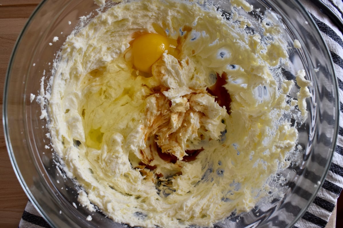 Eggs, vanilla and butter mixed in a bowl.
