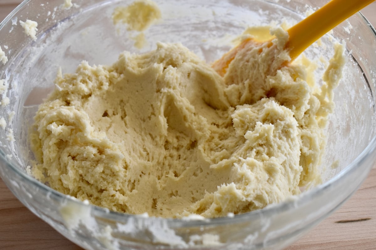 Cookie batter mixed together in a glass bowl.