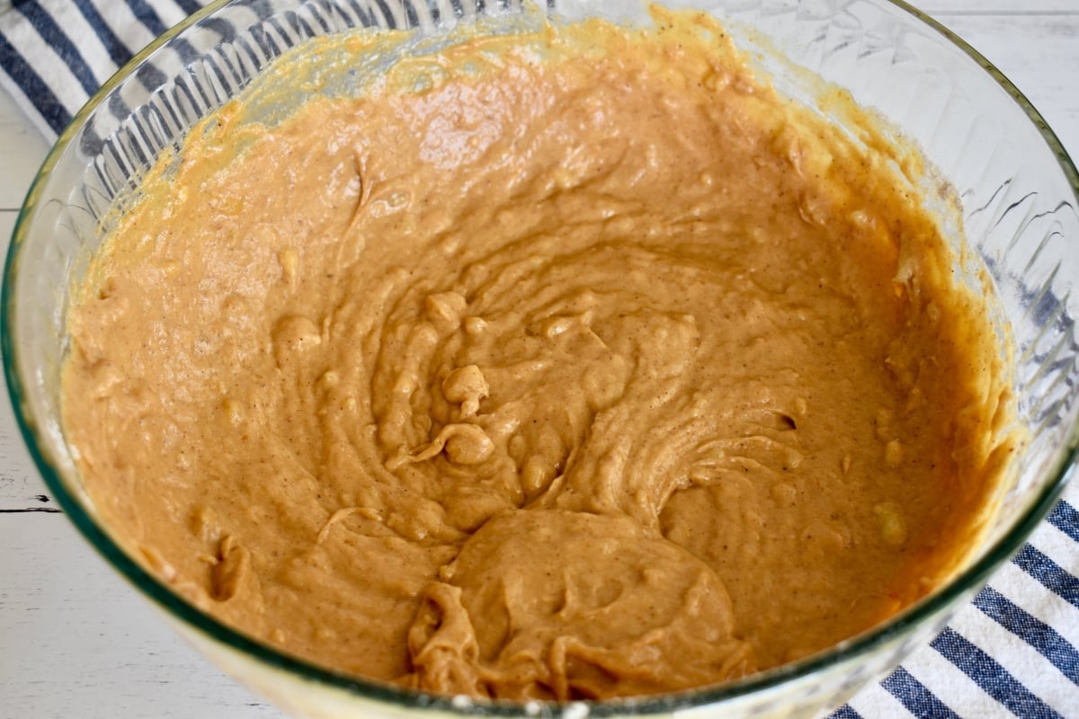 Pumpkin Banana Muffins batter in a large glass bowl.